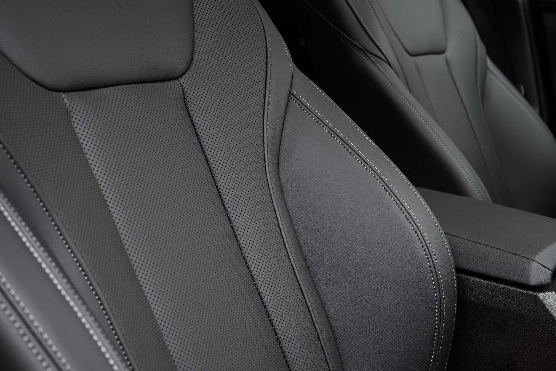 Black Perforated Leather Seat White Stitching Closeup